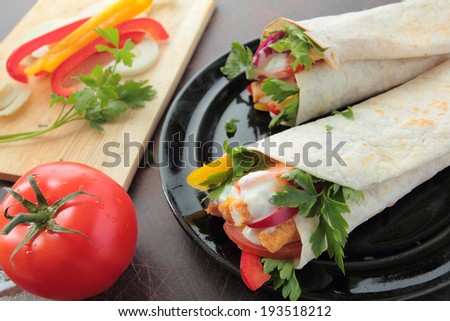 Tortilla with tasty chicken, vegetables and garlic dressing sauce