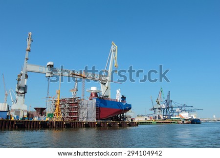 GDYNIA, POLAND - JUNE 13, 2015: Building a ship. 1000-ton Gantry Crane in Gdynia Shipyard, Poland. One of the largest in Europe Gantry Cranes with dimensions of 106 m high, 153 m wide.