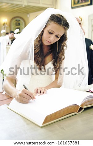 Bride signing wedding book