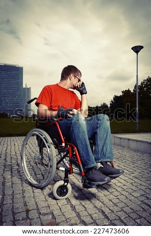 Man in city park on wheel chair