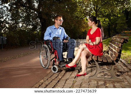 Disable man on wheel chair with girlfriend