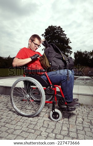 Young man on wheel chair - daily routine