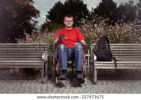 Man on wheel chair enjoying day in park