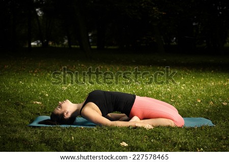 Freshly pregnant nice woman exercising yoga outdoor