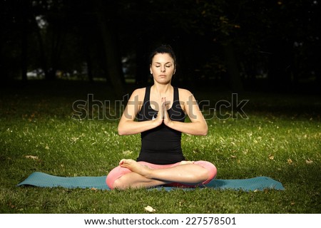 Relaxing and meditating woman in park