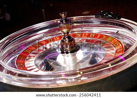 Rotating transparent roulette wheel in casino made of synthetic glass