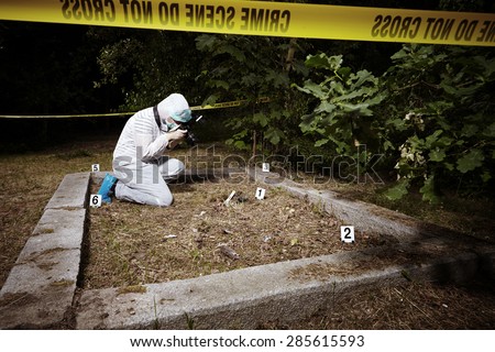 Crime scene investigation - police photographer at work