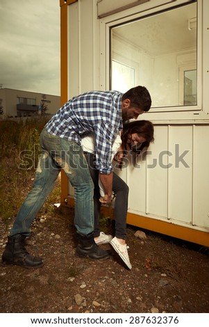 Strong evil man catching woman