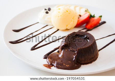 chocolate lava cake set with ice cream and strawberry on white plate