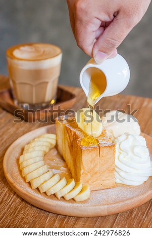 Honey toast, pouring honey on toast