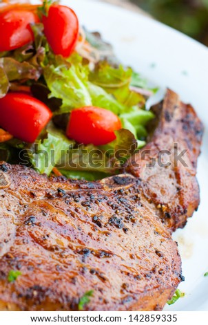Pork chop with salad close up