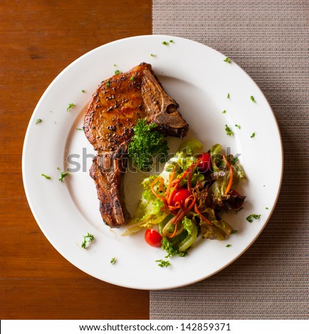 Pork Chop With Salad On Table Top View