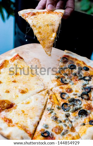 Napole pizza and Cheese pizza slice on  hand