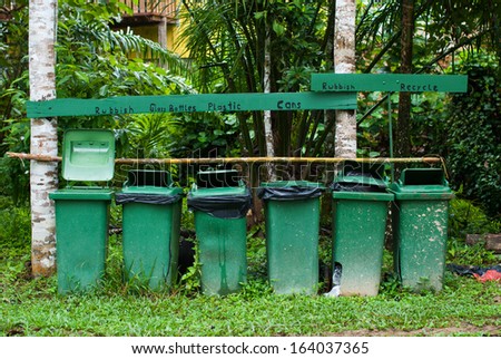 Row of large Green plastic trash for recycling and garden waste