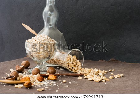A Healthy Dry Oat meal with nut in a wooden spoon on Black background