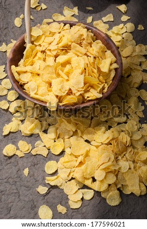 corn flakes in wooden bowl with spoons and Red heart on a table