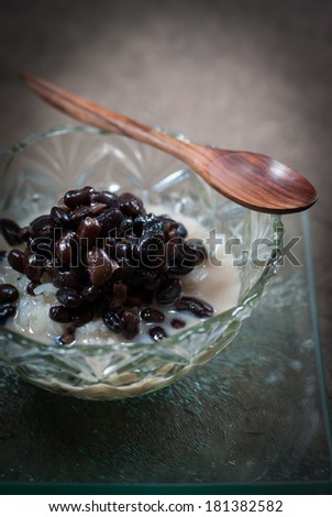 Thailand dessert sticky rice with black beans and coconut cream on Gray background