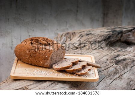 Several slices of Bread wheat and wooden chopping board , Close up