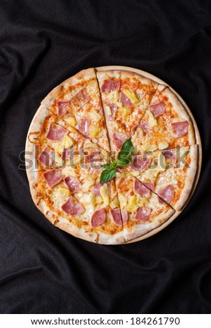 hawaiian Pizza , pineapple , ham and cheese on wooden table