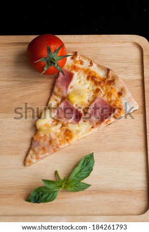 hawaiian Pizza , pineapple , ham and cheese on wooden table
