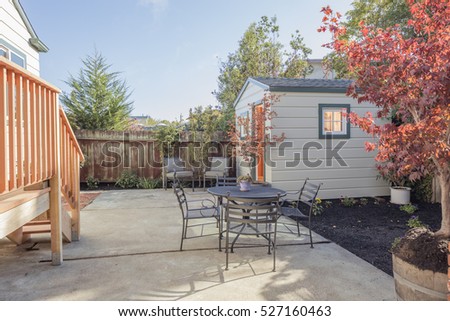 Yard with garden and shed and seating arrangement.