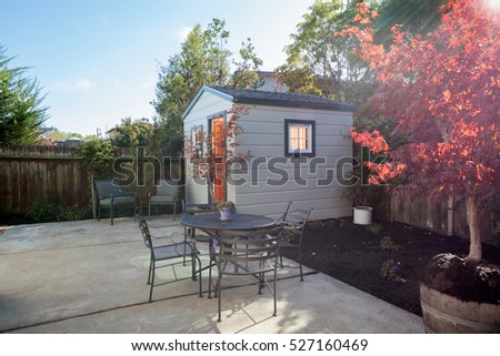 Yard with garden and shed and seating arrangement.