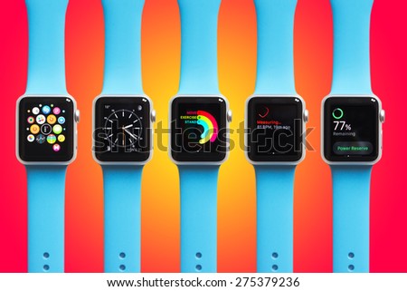 BOLOGNA, ITALY - APR 30, 2015: the Apple Watch. The first wrist device produced by Apple. Different screen samples displayed on gradient colorful background.