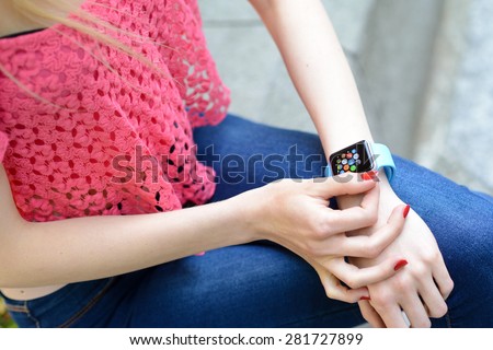 BOLOGNA, ITALY - MAY 17, 2015: One girl touches  the apple watch