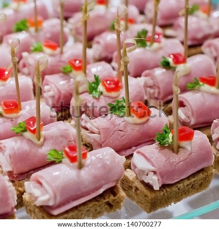 Party nibble of ham and feta cheese on a cocktail stick