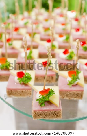 Party nibble of ham and feta cheese on a cocktail stick
