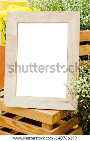Picture frame and flowers on a dresser in a contemporary