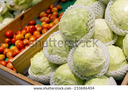 Booth with vegetables at the market, cabbages, tomatoes