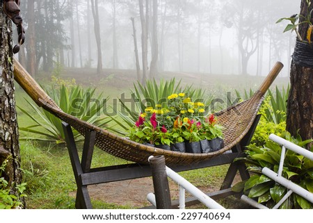 Small Park decorate with colorful flowers and rattan container. Garden design and decoration.