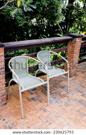 Out door couple of rattan chairs.