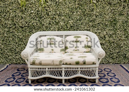 Decorate sofa and carpet against the green small tree wall.