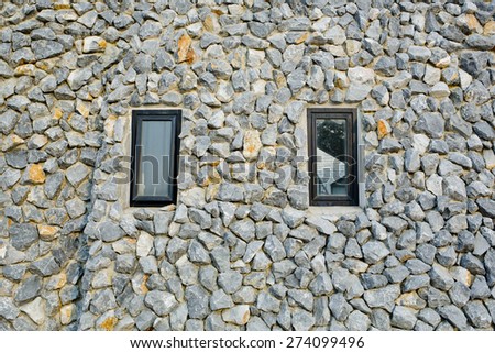 Rock wall with two narrow windows