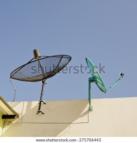 Black and Green Satellite dishs on the roof. Two Satellite dishs on the roof