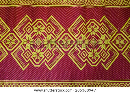 fabric texture red brown, terracotta. Painting on silk cloth. Thai painting pattern of golden brown silk cloth full frame.