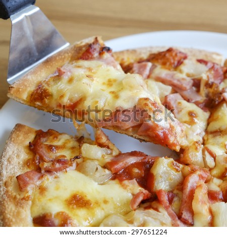 delicious hawaiian rustic style pizza made with fresh pineapples,ham and mozzarella cheese