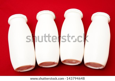 milk cans on a red background