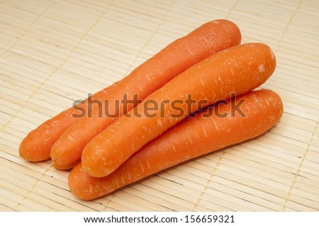 raw carrots on a wooden background