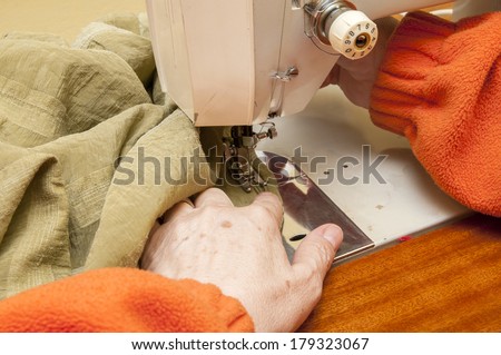 woman sewing clothes in a sewing machine