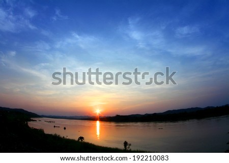 sunset over dark river