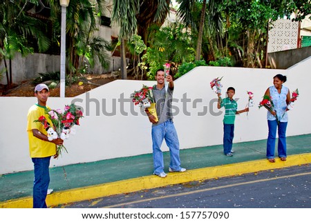 PANAMA CITY, PANAMA, DECEMBER 20 2006.  Two men, one woman and one girl selling flowers on the street, in Panama City, on December 20th 2006. FOR EDITORIAL USE ONLY.