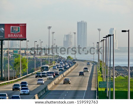 PANAMA CITY, PANAMA, DECEMBER 20 2006. Cars driving in the highway with a skyscraper, sea and cloudy sky in the background, in Panama City, on December 20th 2006.