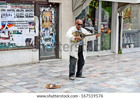 OHRID, MACEDONIA, MAY 17, 2011. A street musician playing and singing on the street, in Ohrid, Macedonia, on May 17th, 2011.