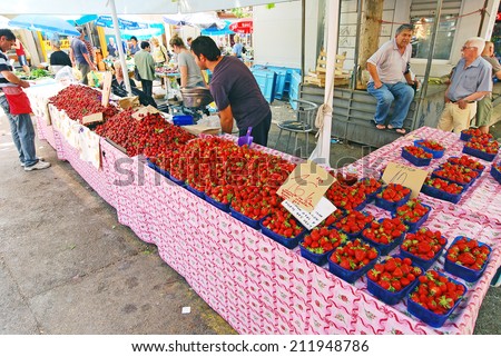 SPLIT, CROATIA, MAY 26, 2011. People selling red strawberried in the main open air market in Split, Croatia, on May 26th, 2011.