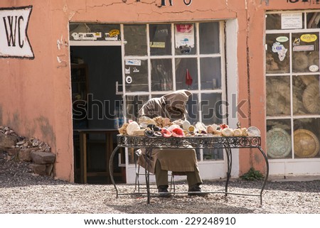 TISLDAY, MOROCCO, MARCH 10, 2014. A Moroccan fossile salesman has passed out in his chair in Tislady, Morocco, on March 10th, 2014.
