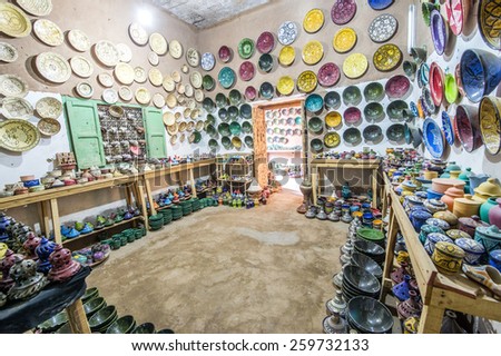 TAMEGROUTE, MOROCCO, MAY 13, 2014. Plates, pots and artifacts made of clay hanging in the wass inside the famous Maison de poterie Tamegroute, Morocco, on May 13th, 2014.
