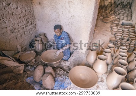TAMEGROUTE, MOROCCO, MAY 13, 2014. A Moroccan man manifacturing plates and pots of clay at the famous Maison de poterie Tamegroute, Morocco, on May 13th, 2014.